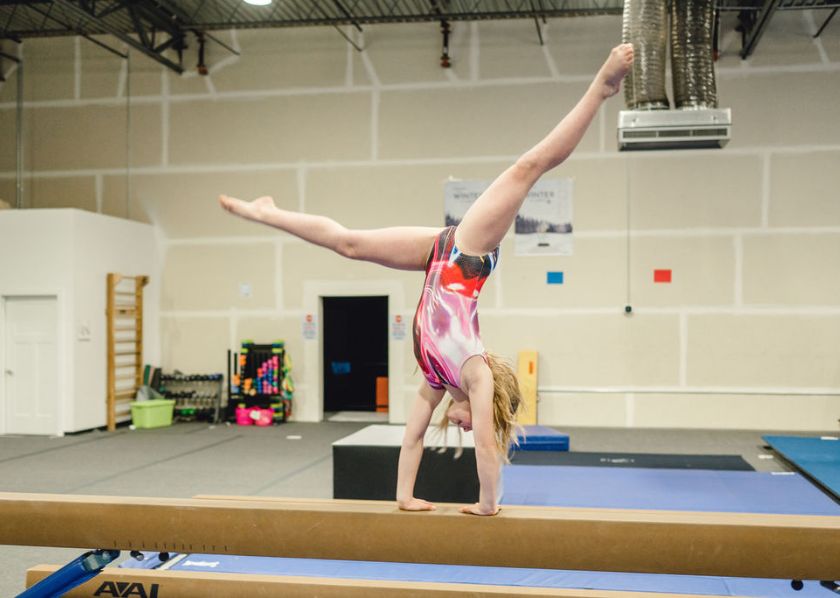 Overcoming Fear gymnast doing a cartwheel on the high beam