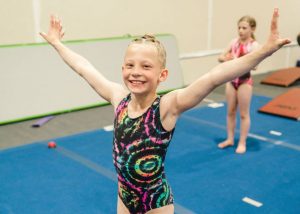 Overcoming Fear gymnast smiling after completing a skill that she is afraid of