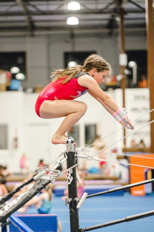 gymnastics terms gymnast doing a squat on