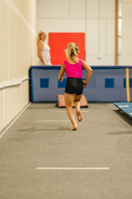 Gymnastics Skills gymnast running on the tumble strip