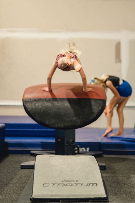 gymnastics terms gymnast doing a vault in a gym