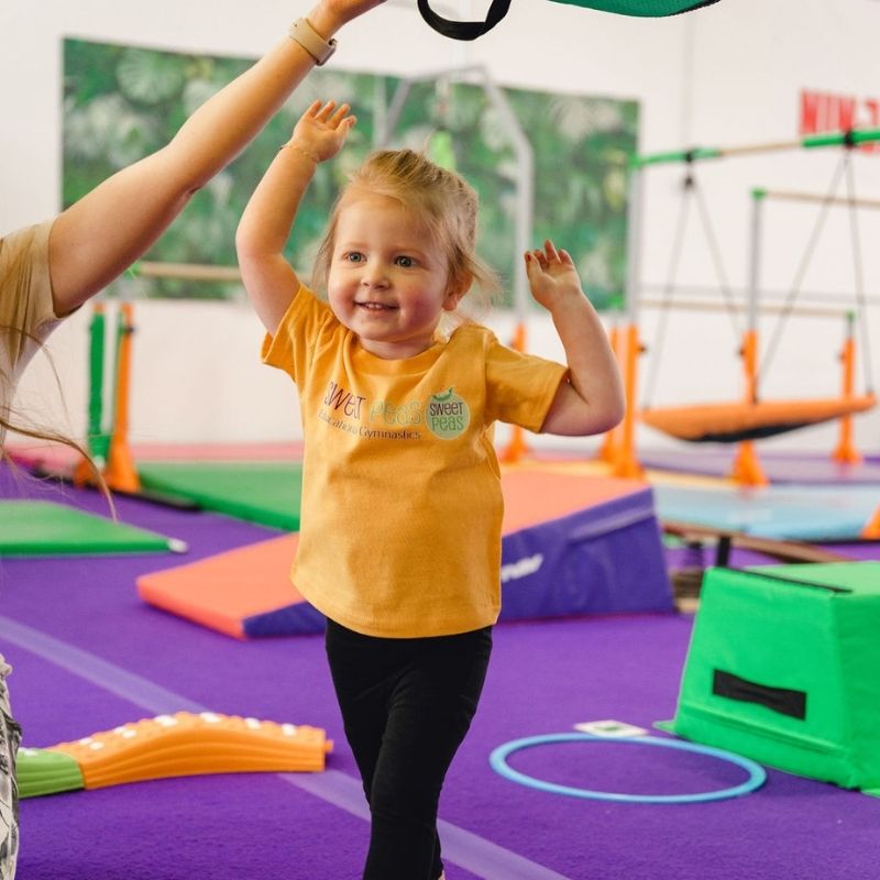 Consistency kid celebrating in preschool gymnastics class