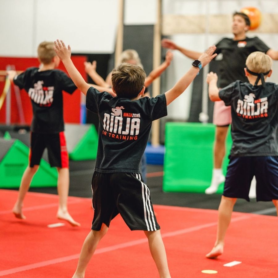 Multi-Discipline Training kids doing jumping jacks in class