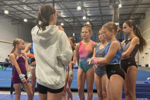 build confidence kids standing around coach listening