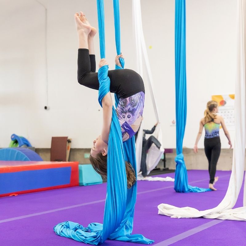 Help in School kid working on silks skills