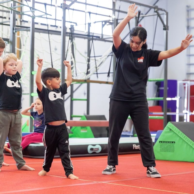 kids activity coach helping guide students in class