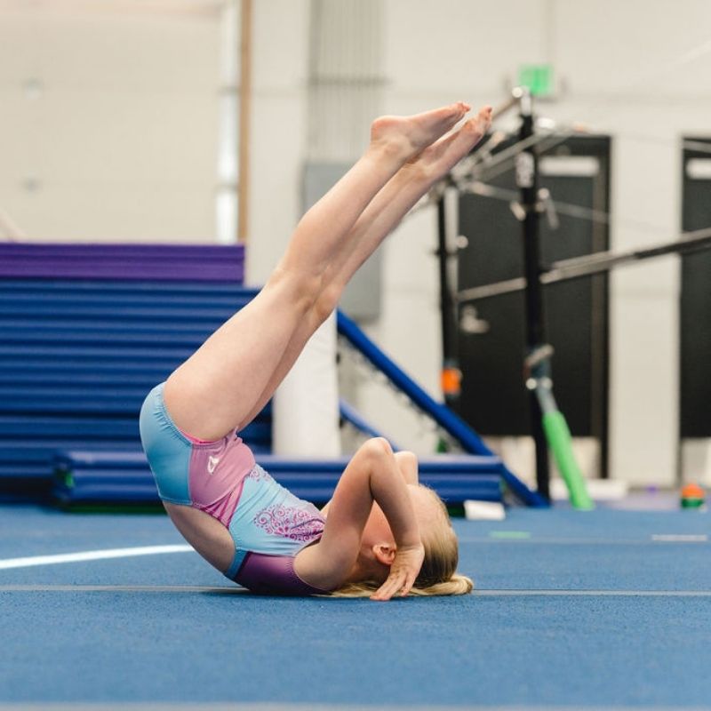 gymnastics age doing a backwards roll on the floor