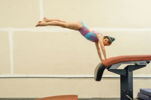 Growth spurt kid jumping on the vault table