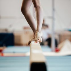 competition gymnastics exercises on balance beam girl gymnast